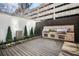 Outdoor grill station with stainless steel appliances, a water feature and wood flooring at 199 14Th Ne St # 402, Atlanta, GA 30309