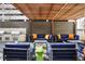 Relaxing outdoor seating area with comfortable couches and a grilling station under a pergola at 199 14Th Ne St # 402, Atlanta, GA 30309
