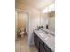 Well-lit bathroom featuring granite counters, dark wood cabinets, and tiled floors at 265 Enfield Ln, Mcdonough, GA 30252