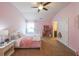 Pink bedroom featuring carpet flooring, natural light, and a white bed frame at 265 Enfield Ln, Mcdonough, GA 30252