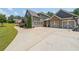 Spacious driveway leading to a three-car garage with a basketball hoop at 265 Enfield Ln, Mcdonough, GA 30252