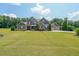 Beautiful home with a well-kept lawn and a three-car garage with a basketball hoop at 265 Enfield Ln, Mcdonough, GA 30252