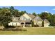 Charming two-story home with stone accents, manicured lawn, and mature trees at 265 Enfield Ln, Mcdonough, GA 30252