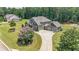 Traditional home exterior with a well-manicured front yard, complemented by a beautiful flowering tree at 265 Enfield Ln, Mcdonough, GA 30252