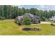 Charming exterior featuring lush green lawn, mature trees, and meticulous landscaping at 265 Enfield Ln, Mcdonough, GA 30252