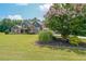 Beautiful two-story home with stone and siding, lush landscaping, and a well-manicured lawn at 265 Enfield Ln, Mcdonough, GA 30252