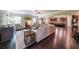 Open-concept living room with hardwood floors, fireplace, and access to kitchen at 265 Enfield Ln, Mcdonough, GA 30252