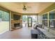 Outdoor patio with fireplace, a ceiling fan and comfortable lounge furniture at 265 Enfield Ln, Mcdonough, GA 30252
