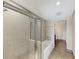 Bathroom with a shower-tub combination featuring glass doors and ceramic tile surround at 3338 Peachtree Ne Rd # 508, Atlanta, GA 30326
