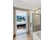 Ensuite bathroom featuring shower with glass door and view of bedroom and downtown at 3338 Peachtree Ne Rd # 508, Atlanta, GA 30326