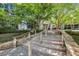 Stairs lead to a modern building entrance, surrounded by lush greenery at 3338 Peachtree Ne Rd # 508, Atlanta, GA 30326