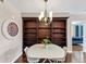 Dining area featuring built-in shelving, a modern chandelier, and access to the balcony at 3338 Peachtree Ne Rd # 508, Atlanta, GA 30326