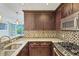 Kitchen featuring dark wood cabinets, granite countertops, and stainless steel appliances at 3338 Peachtree Ne Rd # 508, Atlanta, GA 30326