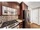 Beautiful kitchen features stainless steel appliances, granite countertops, and wood cabinetry at 3338 Peachtree Ne Rd # 508, Atlanta, GA 30326