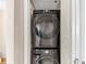 Stackable washer and dryer setup tucked behind a closet door maximizing space at 3338 Peachtree Ne Rd # 508, Atlanta, GA 30326