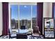 A cozy living room with a city view, featuring modern furnishings, purple drapes, and lots of natural light at 3338 Peachtree Ne Rd # 508, Atlanta, GA 30326
