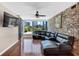 Spacious living area with a gray leather sofa, brick wall, and large windows at 3338 Peachtree Ne Rd # 508, Atlanta, GA 30326