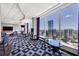 A spacious lounge area with floor to ceiling windows and a stunning city view in the distance at 3338 Peachtree Ne Rd # 508, Atlanta, GA 30326