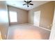 Bedroom with neutral paint, a window, a ceiling fan, carpet, and white trim at 3878 Hannahberry Pl, Buford, GA 30519