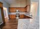 Kitchen featuring stainless steel appliances, granite countertops, and custom cabinetry at 3878 Hannahberry Pl, Buford, GA 30519