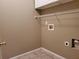 Small laundry room featuring overhead shelving, a tile floor, and hookups for a washer and dryer at 3878 Hannahberry Pl, Buford, GA 30519