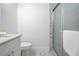 Bright bathroom featuring marble tile, white cabinets, shower with glass door and chrome towel bar at 1993 Reynolds Sw Dr, Atlanta, GA 30315