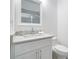 Bathroom vanity with white cabinets, light countertop, a square mirror, and chrome faucet at 1993 Reynolds Sw Dr, Atlanta, GA 30315