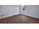 Bedroom featuring new wood flooring, white walls, and a view to the outdoors at 1993 Reynolds Sw Dr, Atlanta, GA 30315