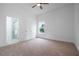 A carpeted bedroom with en suite bathroom, bright light, and a ceiling fan at 1993 Reynolds Sw Dr, Atlanta, GA 30315