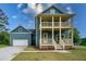 Charming two-story home features a double porch, blue siding, and an attached garage at 1993 Reynolds Sw Dr, Atlanta, GA 30315