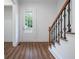 Bright foyer featuring hardwood floors, white walls, and a stairway with black metal accents at 1993 Reynolds Sw Dr, Atlanta, GA 30315