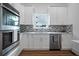 Modern kitchen with white cabinetry, stainless steel appliances, tile backsplash, and natural light at 1993 Reynolds Sw Dr, Atlanta, GA 30315