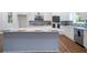 Bright kitchen with a large island, stainless appliances, white cabinets, and stylish backsplash at 1993 Reynolds Sw Dr, Atlanta, GA 30315