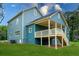 View of the back of the home, showcasing a covered porch, a back yard, and yard space at 1993 Reynolds Sw Dr, Atlanta, GA 30315