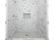 Tiled walk-in shower featuring marble tile, built-in niche, and shower head at 1993 Reynolds Sw Dr, Atlanta, GA 30315
