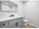 Bathroom featuring modern grey vanity, sleek black hardware and a well-lit mirror for optimal grooming at 3156 Ozmer Lndg, Decatur, GA 30034