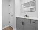 Modern bathroom featuring gray vanity with black hardware and framed mirror at 3156 Ozmer Lndg, Decatur, GA 30034