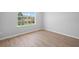 Bright bedroom with light hardwood floors and a large window offering a neighborhood view at 3156 Ozmer Lndg, Decatur, GA 30034