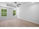 Bright bedroom with tray ceilings, ceiling fan, and view of the outdoors at 3156 Ozmer Lndg, Decatur, GA 30034