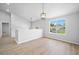 Bright living room featuring wood floors, a large window, and stylish light fixtures at 3156 Ozmer Lndg, Decatur, GA 30034