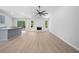 Spacious living room with hardwood floors, a modern kitchen, a cozy fireplace, and great natural light at 3156 Ozmer Lndg, Decatur, GA 30034