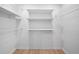 This walk-in closet provides generous storage with installed shelving and wood-look flooring at 3156 Ozmer Lndg, Decatur, GA 30034