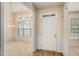 Bright foyer featuring a white front door, wainscoting, and views into the adjacent dining and living spaces at 3634 Cape Ln, Conyers, GA 30013