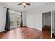 Bright bedroom with hardwood floors, ceiling fan, and access to a private balcony at 400 17Th Nw St # 1321, Atlanta, GA 30363
