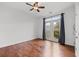 Bedroom features hardwood floors, a ceiling fan, and balcony access at 400 17Th Nw St # 1321, Atlanta, GA 30363
