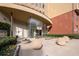 Welcoming building entrance with stone accents, spherical planters, and well-maintained landscaping at 400 17Th Nw St # 1321, Atlanta, GA 30363