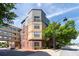 Attractive building exterior with brick and stucco, complemented by mature trees and street view at 400 17Th Nw St # 1321, Atlanta, GA 30363