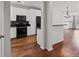 Open kitchen with white cabinets, black appliances, hardwood floors, and an eat-in bar at 400 17Th Nw St # 1321, Atlanta, GA 30363