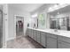 Elegant bathroom with double vanities and a walk-in shower, complemented by bright lighting at 510 Cunninghame Ct, Peachtree City, GA 30269