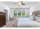 Well-lit bedroom featuring a large window offering a view of the lush, green outdoors at 510 Cunninghame Ct, Peachtree City, GA 30269